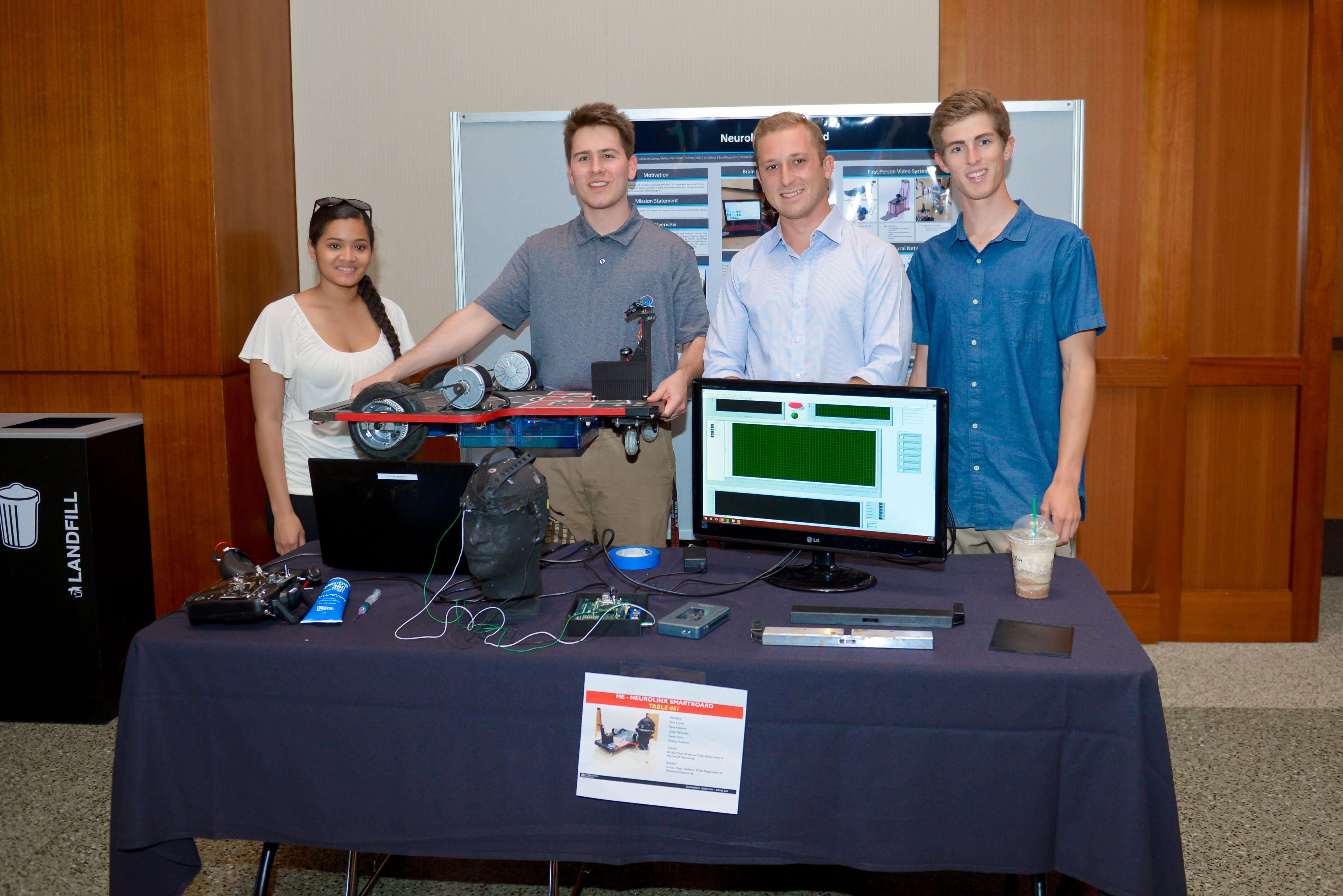 Four students displaying their computer and project.