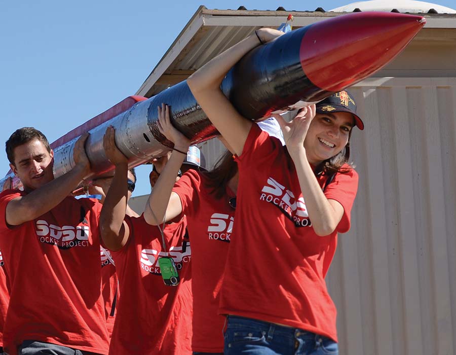 Aerospace Engineering students carry a rocket to the launch site
