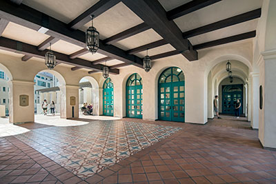 The ASML Plaza, a Mediterranean-style arcade with large turquoise doors, patterned tiles, and hanging lanterns.