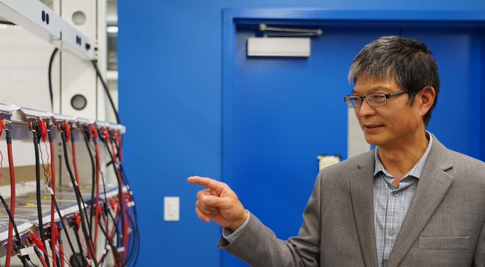 Electrical engineer Chris Mi pointed to cables leading to his lab's environmental testing chamber, which measures battery performance in different temperature conditions. (Photo: Christopher Leap)