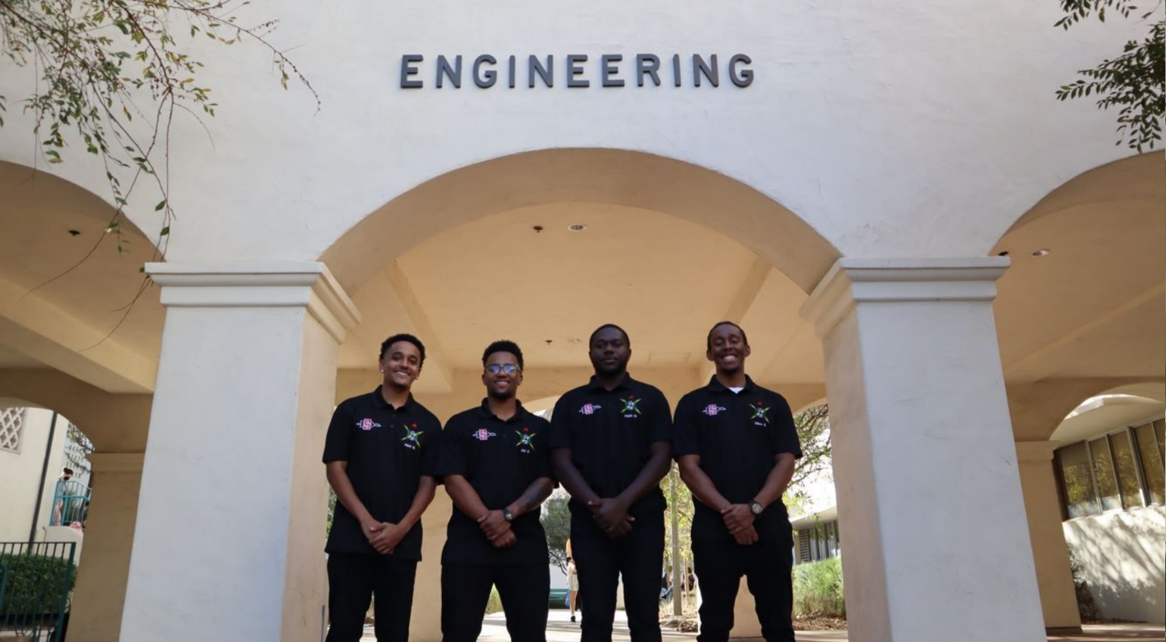 NSBE members Abel Napoleon, Abi Daniel, Aquin Manners, Miles Gordon pose outside the College of Engineering at SDSU.