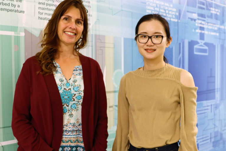 Natalie Mladenov (left) and Junfei Xie (right) pose in the Clark Construction Innovation Pathway of the Engineering and Interdisciplinary Sciences (EIS) Building.