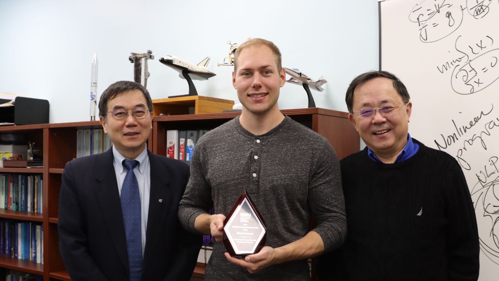 Ryan Callan stands with Xiaofeng Liu (left) and Ping Lu (right)