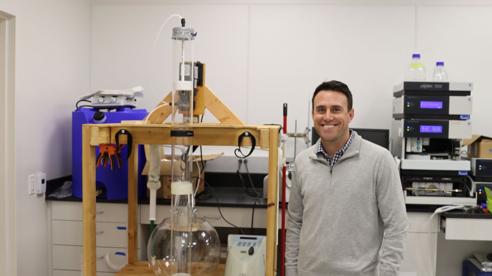 SDSU m​aster's student Ryan McDowell studying under Dr. Hassan Davani stands with a prototype rain garden in the lab.